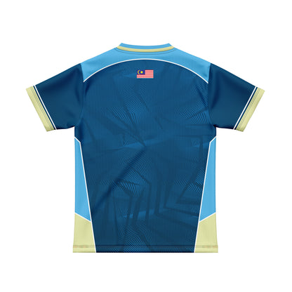 A short-sleeve athletic jersey shown from the back, featuring a dark blue body with a subtle geometric pattern, light blue side panels, pale yellow trim, and a small Malaysian flag emblem near the upper back.
